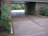 New decorative concrete driveway with picture frame borders, in Autumn Brown color, with Walnut accents, by Surface Systems of Texas