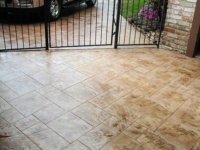 Stamped polymer concrete overlay system rejuvenates a concrete breezeway and driveway, from Surface Systems of Texas