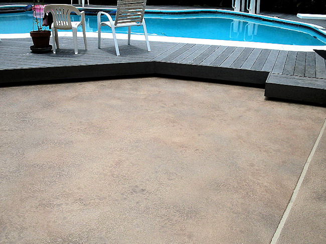 TerraStone polymer concrete overlay in mottled coloring on a pool deck, from Surface Systems of Texas